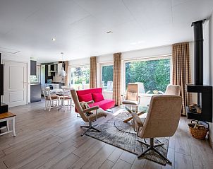 Bright and open interior of Holiday home Slufterhoek 174 in De Cocksdorp, Texel, with modern furnishings and large windows.