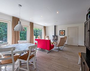 Spacious living room with lots of natural light in Holiday home Slufterhoek 174, De Cocksdorp, Texel, perfect for relaxation.