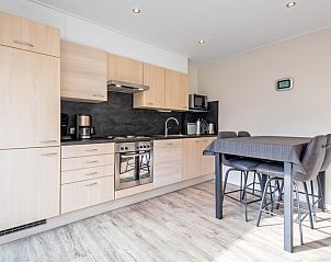 Modern kitchen in Holiday home Slufterhoek 102, De Cocksdorp, Texel with dining area and all necessary amenities for a comfortable stay.