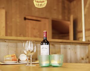 Wooden interior of Sluftervallei safari tent, Texel, with cozy dining area.