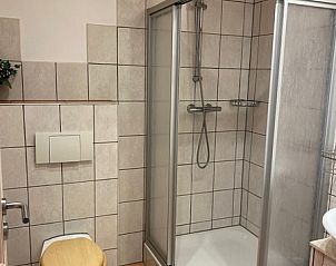 Badezimmer im Ferienhaus Slufterhoek 128, De Cocksdorp Texel, mit moderner Dusche und Toilette.