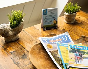 Detail des Esstisches im Bungalow Pier 53, Texel, mit lokalen Broschren und gemtlicher Atmosphre.