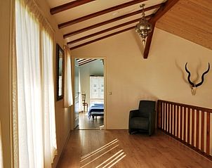 Sunny upstairs hall of Cottage in De Cocksdorp, Texel, with wooden details.