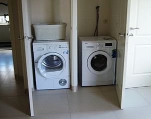Practical laundry room in cottage in De Cocksdorp, Texel, with washer and dryer.