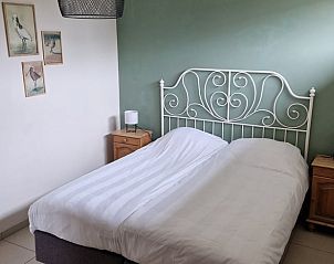 Comfortable bedroom in Cottage in De Cocksdorp, Texel, with double bed and bedside tables.