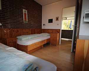 Bedroom in Holiday home Slufterhoek 168, Texel, with wooden interior and comfortable beds.