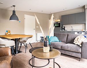 Spacious kitchen in Type C Apartment de Stoeterij, De Cocksdorp, Texel, complete with modern appliances and comfortable seating area.