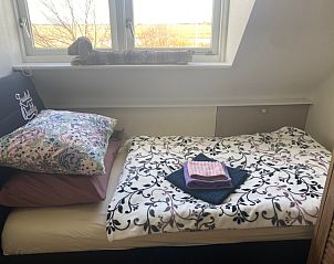Cozy bedroom in Family House Dacha, De Cocksdorp, Texel overlooking the nature of the Wadden Islands.