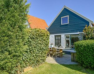 Enjoy the terrace at De Vlinder, a vacation home in De Cocksdorp, Texel, surrounded by green nature.