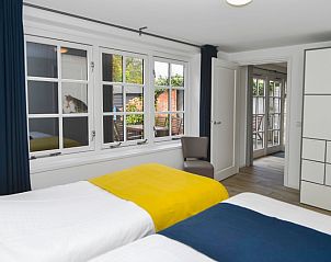 Attractive bedroom in Het Kwade Konijn, vacation home in De Cocksdorp, Texel, with fresh furnishings and garden views.