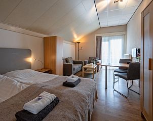 Spacious bedroom in Type 1 - 2100 vacation home in De Cocksdorp, Texel, with comfortable bed and sitting area.