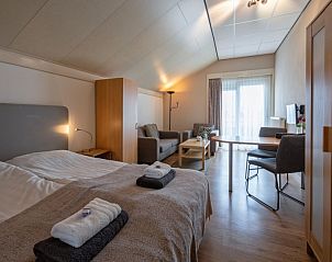 Cozy indoor area of Type 1 - 2100 vacation home in De Cocksdorp, Texel, with dining and sitting area.