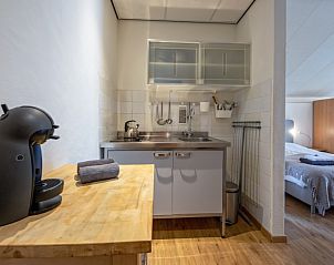 Compact kitchen in Type 1 - 2100 vacation home, De Cocksdorp, Texel, with coffee maker and cooking facilities.