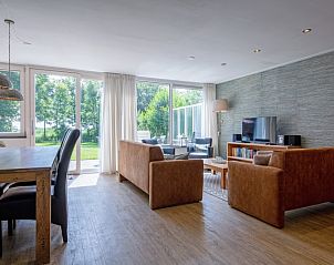 Bright living room in Holiday home Slufterhoek 132, Texel, with large windows and views of nature