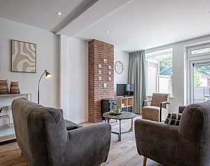 Bright living room with modern furnishings in Holiday home Slufterhoek 104, De Cocksdorp Texel, ideal for family vacations.