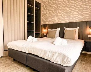 Comfortabele slaapkamer in Huisje in De Cocksdorp, vakantieaccommodatie op Texel, met tweepersoonsbed en moderne inrichting.