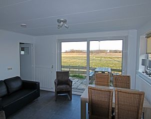 Bright living room of De Roggesloot vacation home, De Cocksdorp, Texel overlooking the field.