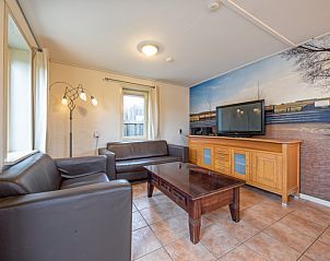 Cozy living room in Tongelen R.D. van, vacation home in De Cocksdorp, Texel. Comfortable sofas and modern furnishings.