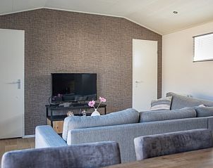 Stylish living room in Chalet Bregkoog 231, De Koog, Texel with television and modern furnishings at Chaletpark Bregkoog.