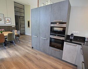 Stylish kitchen of Orchismient 49 vacation home, De Koog, Texel with ample storage and modern finishes.