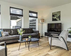 Stylish living room of Villa 41 in De Koog, Texel, with modern decor and lots of natural light.