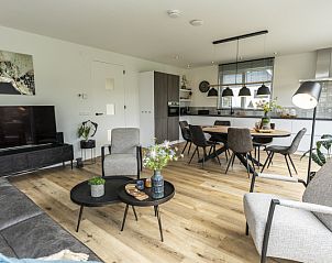 Open kitchen and dining area in Villa 41, vacation home in De Koog, Texel, with contemporary furniture.