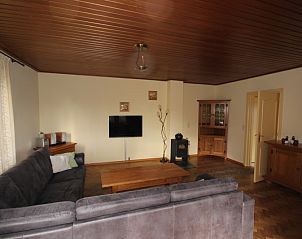 Interior space of Landhuis Landleven No. 81, vacation home in De Koog, Texel with spacious sitting area and wood stove.