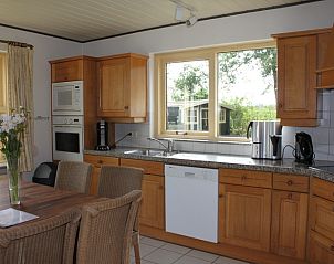 Kitchen of Landhuis Landleven No. 81, vacation home in De Koog, Texel with modern amenities and dining area.