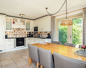 Stylish kitchen in Villa, De Koog, Texel with modern appliances and cozy dining area.