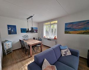 Dining room of Residence California - Geborchenheit - 361 in De Koog, Texel, with wooden table and art on the wall.