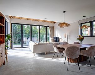 Dining area in Villa Flo, De Koog, Texel with modern dining area and natural light.