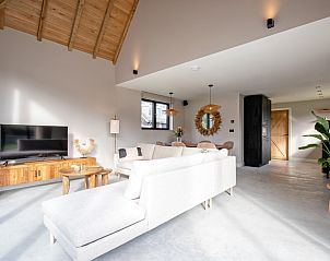 Spacious living room of Villa Flo, Texel with comfortable sofa and entertainment options.