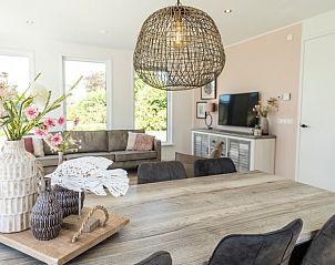 Cozy dining area in Villa 35a, De Koog, Texel with decorative lamp.