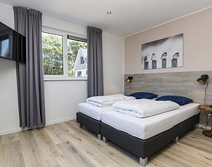 Comfortable bedroom in Villa 35a, De Koog, Texel with a view of nature.