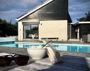 Sunny terrace with pool at Stappeland - Huize 100-1, vacation home in De Koog, Texel, ideal for relaxation.