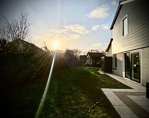 Sunset over the garden of Stappeland - Huize 100-1, vacation home in De Koog, Texel, with serene nature.