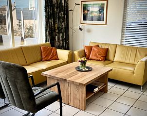Cozy living room in Stappeland - Huize 100-1, vacation home in De Koog, Texel, with comfortable seating.