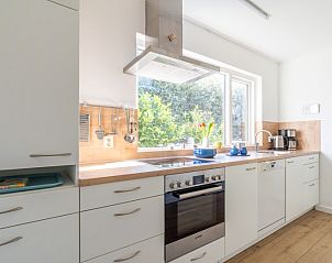 Modern kitchen in Orchismient 14 vacation home De Koog Texel overlooking green garden and all amenities.