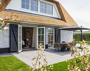 Cozy outdoor area of Villa 25b in De Koog, Texel, with terrace and French doors.