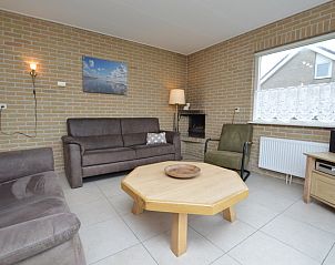 Attractive indoor area of Holiday Home Stappeland 213 in De Koog, Texel with fireplace and spacious seating.