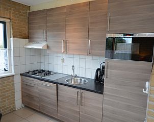 Modern kitchen in Holiday home Stappeland 213, De Koog, Texel with sleek cabinets and built-in appliances.