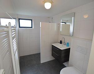 Stylish bathroom in Holiday home Stappeland 213, De Koog, Texel with modern amenities and sleek white tiles.