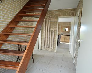 Wooden staircase in Holiday home Stappeland 213, De Koog, Texel leads to upper floor with open and bright hall.