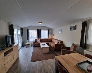 Spacious living space in Chaletpark Bregkoog - Chalet Bregkoog 235, De Koog, Texel with lots of natural light and access to terrace.