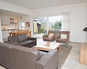 Spacious open living space in Epelaan 31, De Koog, Texel, with access to terrace and views of nature.