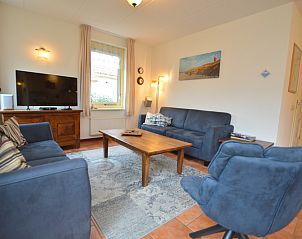 Cozy living room of Holiday Home 7K in De Koog, Texel with comfortable sofas and modern amenities.