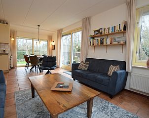 Open living room and dining area in Holiday home 7K, De Koog, Texel overlooking green surroundings, perfect for family vacations.