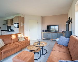 Open living space in Maaikeduinweg 13 vacation home, De Koog, Texel with modern kitchen and cozy sitting area for family stay.