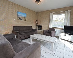 Cozy living room in Holiday home Stappeland 207, De Koog, Texel with comfortable sofas and lots of natural light.