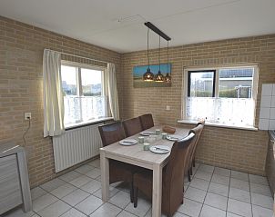Dining room in Holiday home Stappeland 207, De Koog, Texel with stylish dining table and lots of natural light.